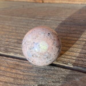 Small pink opal sphere/ball. Raw white patch. (E)